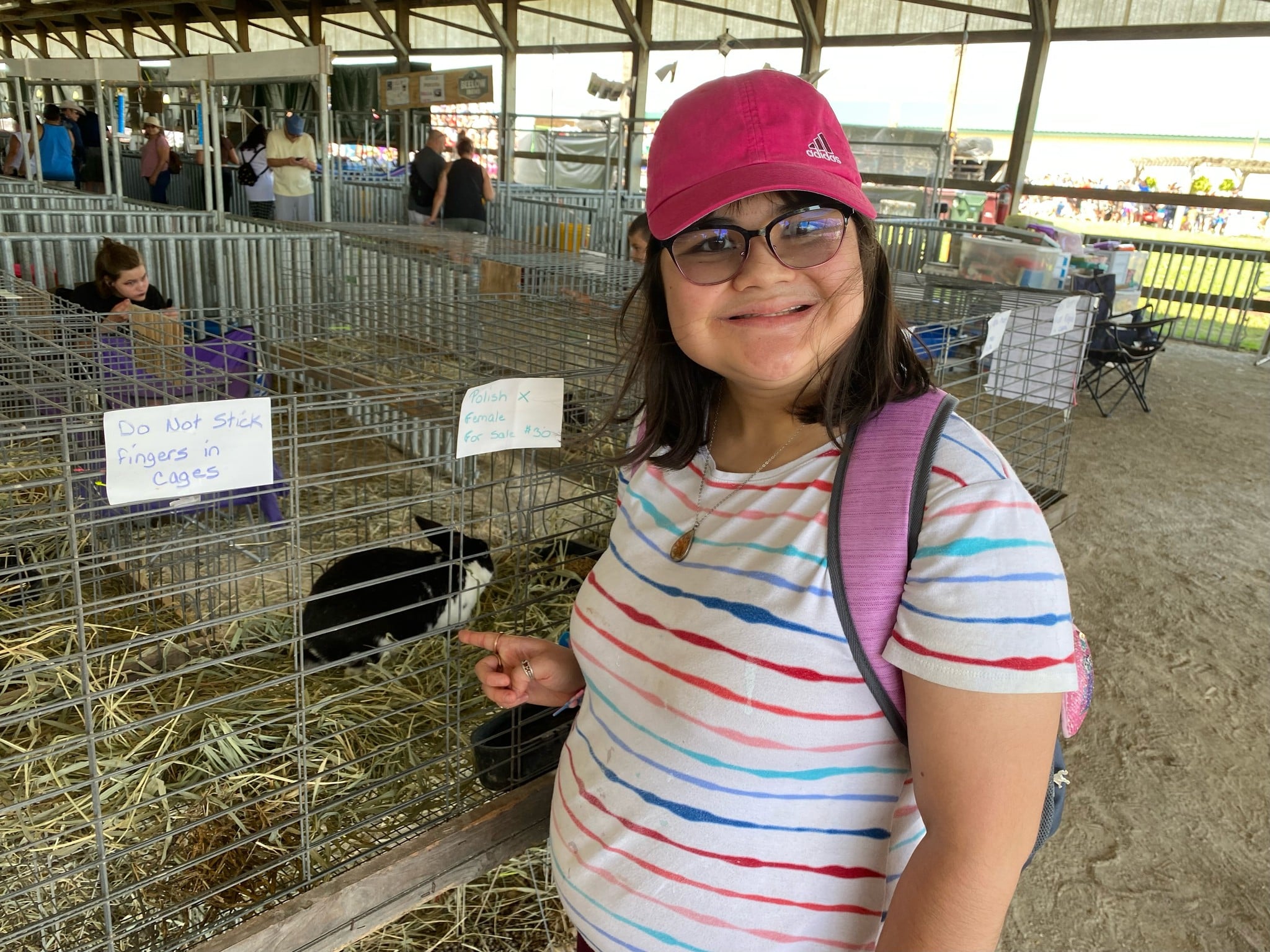 CEL member enjoying an excursion at the Lake Country Fair, smiling in front of a rabbit.