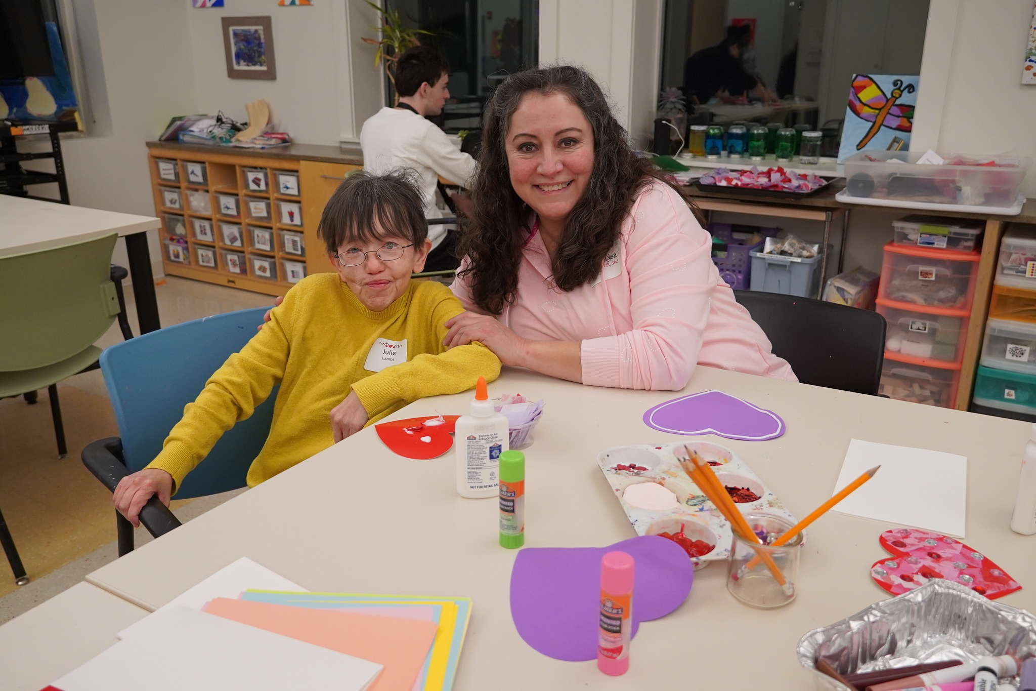 A picture of a CEL member and staff making arts and crafts.
