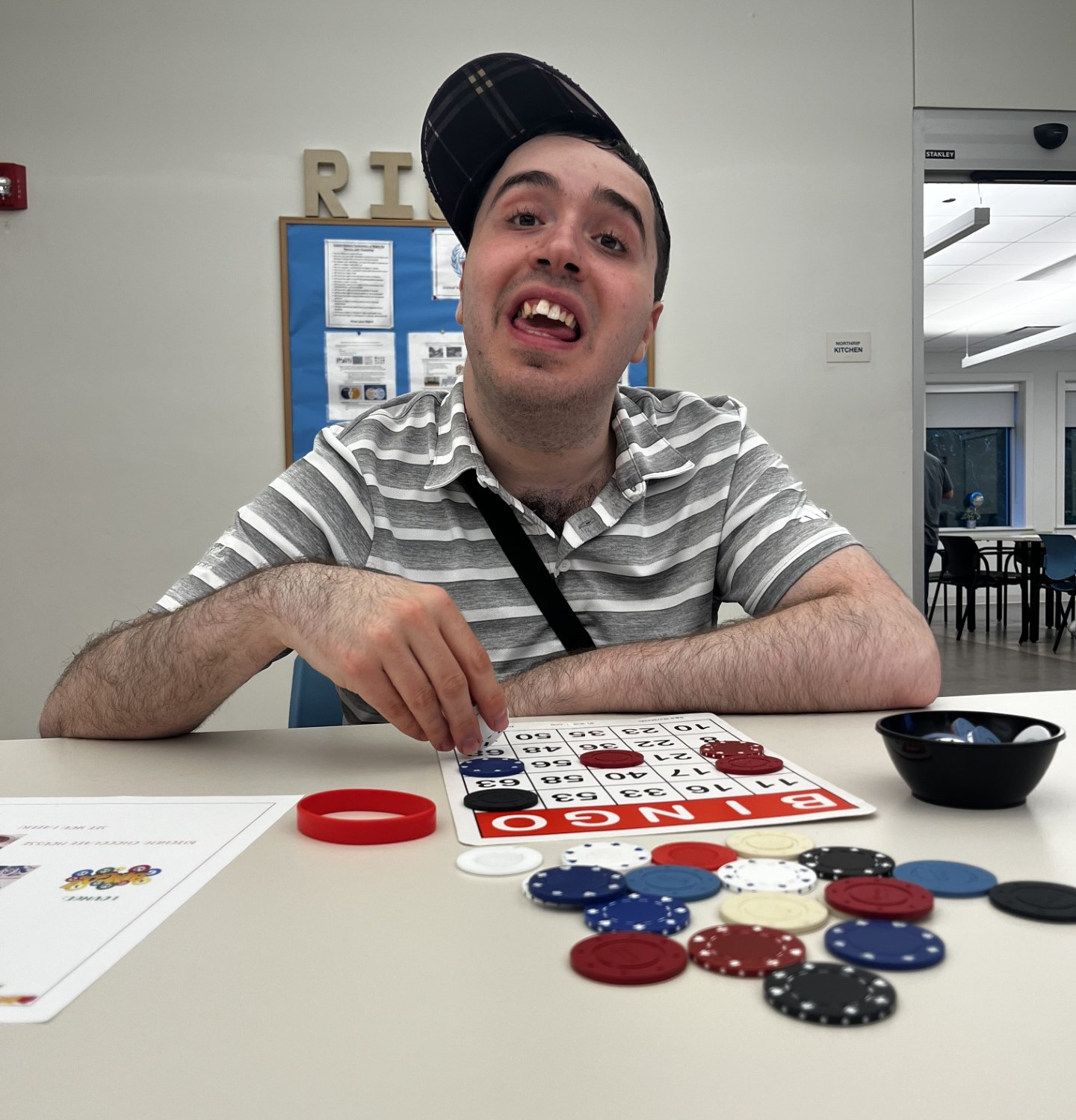 A picture of CEL member Thomas smiling while playing Bingo during Wednesday Night Sampler.